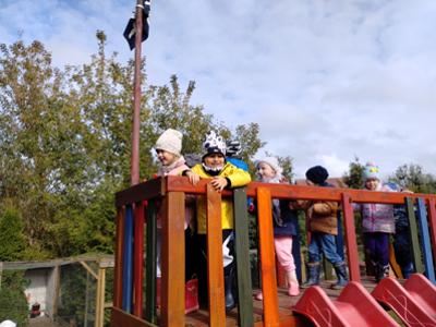 Dzieci podczas zabawy na wieży, ze zjeżdżalnią.