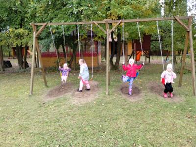 Przedszkolaki podczas zabawy na huśtawkach.