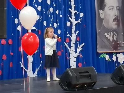 Dziewczynka śpiewa na scenie podczas konkursu piosenki.