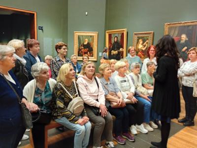 Grupa seniorów z przewodnikiem zwiedzająca Muzeum Narodowe