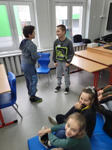 Na zdjęciu znajdują się uczestnicy zajęć. Dzieci wykonują powierzone im zadania.