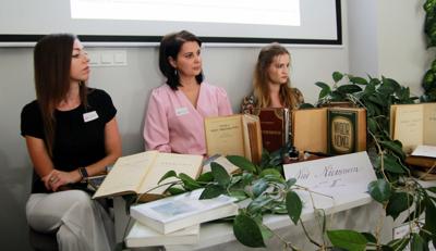 Na zdjęciu z znajdują się pracownicy bibliotek. Zdjęcie wykonano w bibliotece - w tle prezentacja multimedialna.