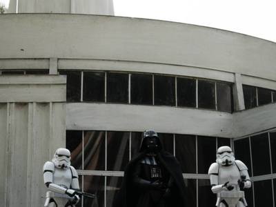 Figurki ze znanej sagi Star Wars przed miniaturą Iglicy poznańskich targów.
