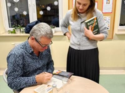 Marcin Meller podpisujący książkę kobiecie.