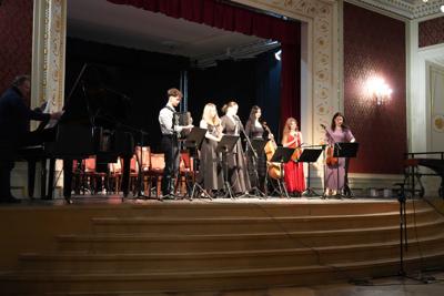 Grupa artystów grająca koncert na scenie.