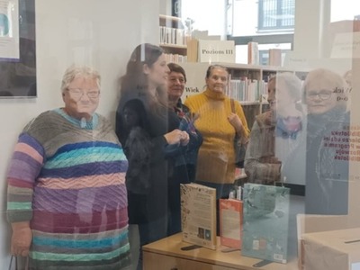 Seniorzy zwiedzają bibliotekę.