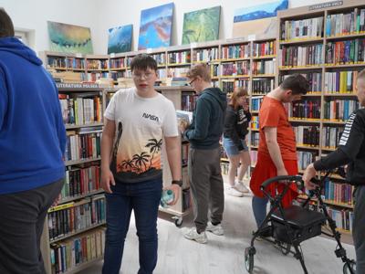 Młodzież z Ośrodka Szkolno - Wychowawczego w Olbięcinie zapoznaje się z księgozbiorem biblioteki.