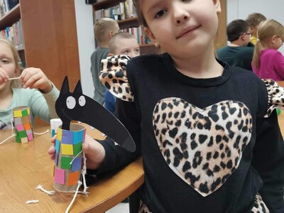 Dziecko prezentuje prace plastyczną