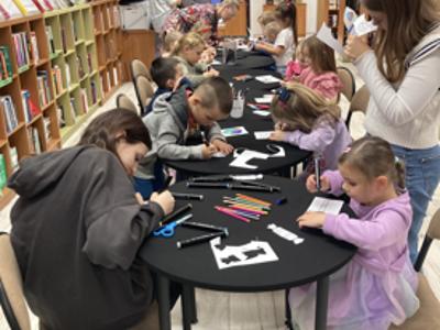 Dzieci w bibliotece tworzą piernikowy domek Baby Jagi
