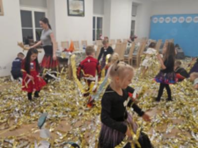 Tańczące dzieci w złotych serpentynach