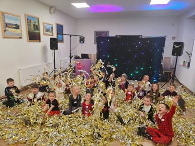 Tańczące dzieci w złotych serpentynach