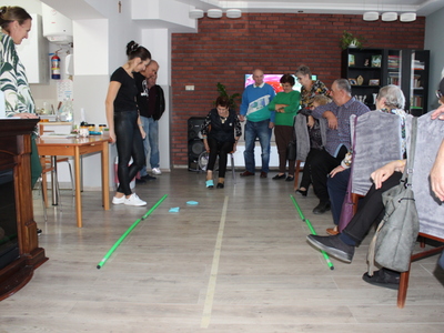 6)	Na fotografii seniorzy w trakcie zabawy z woreczkami.