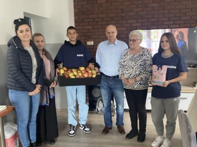 Zdjęcie wykonane na Sali głównej DDP.  Przedstawia uczniów  z Klubu Wolontariatu wraz z opiekunkami, oraz przedstawicieli seniorów.