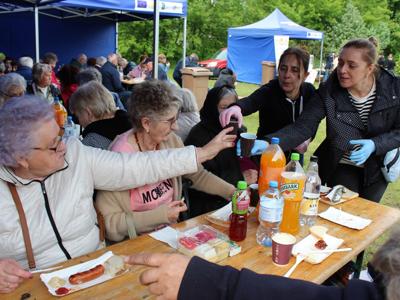 6) Na zdjęciu zobaczyć możemy Seniorów podczas wspólnego posiłku – tj. kiełbaski i kaszanki  z grilla